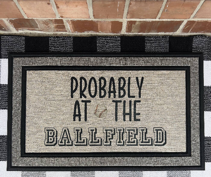 Probably at the ballfield - baseball - Indoor/Outdoor Doormat