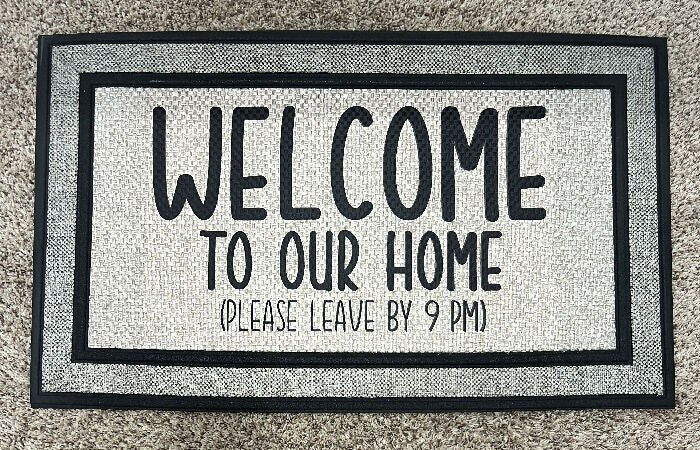 Welcome to our home - please leave by 9 pm Indoor/Outdoor Doormat