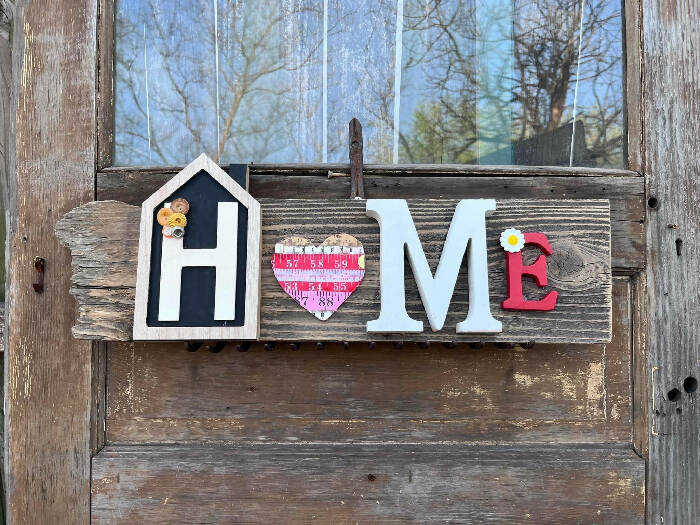 Home sign with tape measure heart