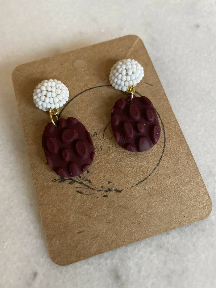 Maroon and white oval dangles