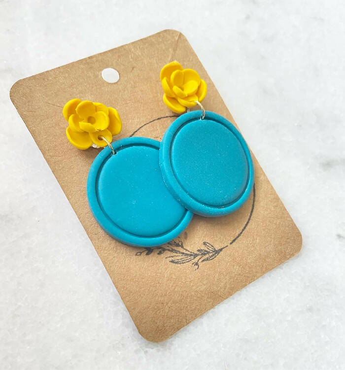 Yellow flower stud with blue circle dangle